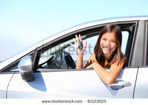 Photo of asian woman smiling in white car