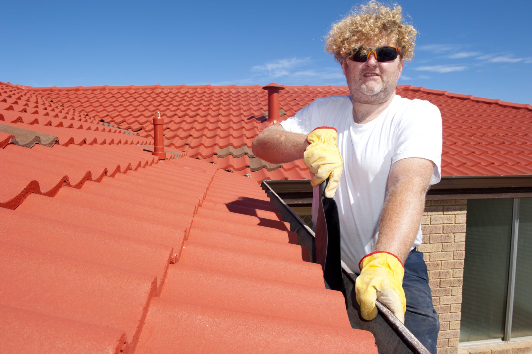 Photo of a man cleaning gutters