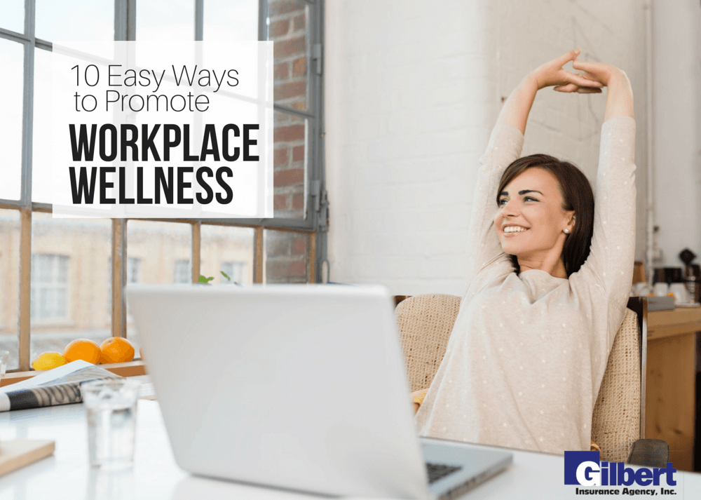 Photo of a woman sitting at a desk stretching her arms