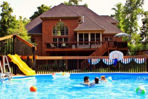 Photo of family swimming in backyard pool