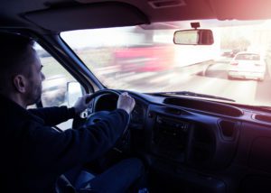 Photo of man driving car on freeway