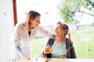 Photo of nurse speaking to older lady in healthcare setting