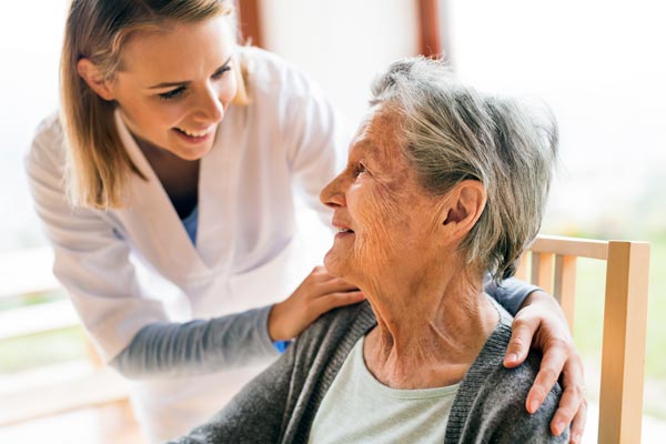 A photo of a caregiver caring for an elderly patient - Insurance for Home Healthcare Professionals in Massachusetts, North Shore MA & Greater Boston
