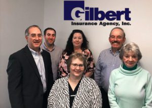 Photo of the Gilbert Insurance team announcing the acquisition of Aljane Insurance