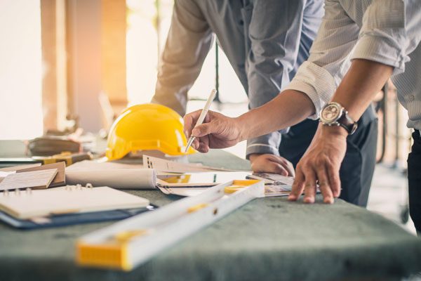 Photo of two contractors reviewing plans, used on our page for Insurance for Artisans and Contractors in Greater Boston & Massachusetts