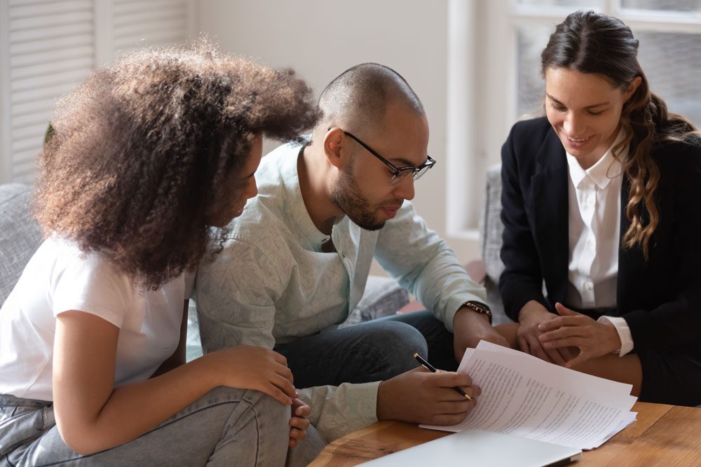 Photo of people reviewing mortgage documents on a table