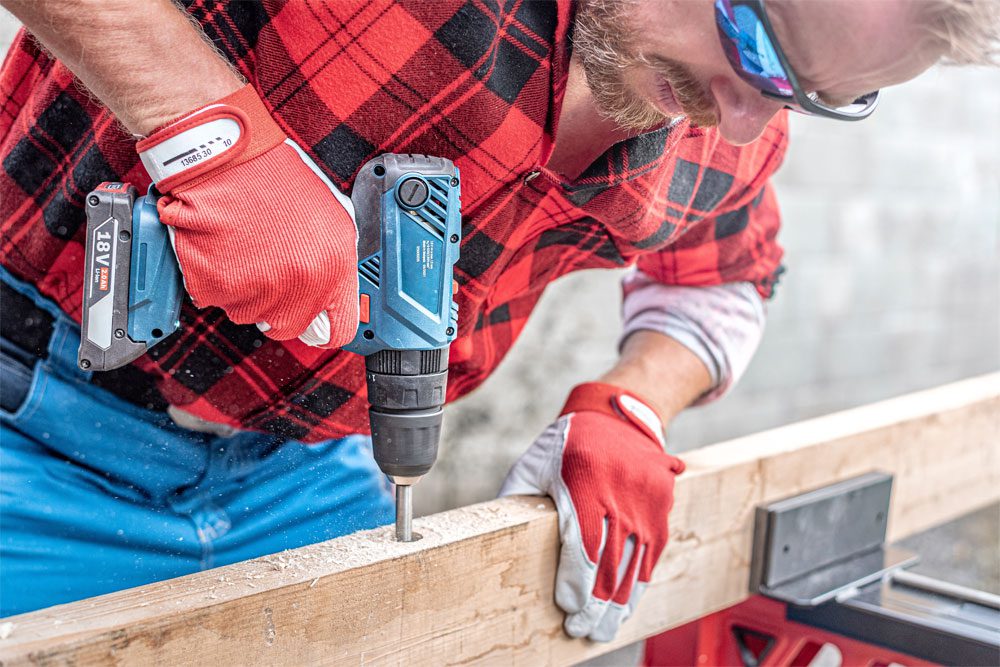 Image of a construction worker using an electric drill